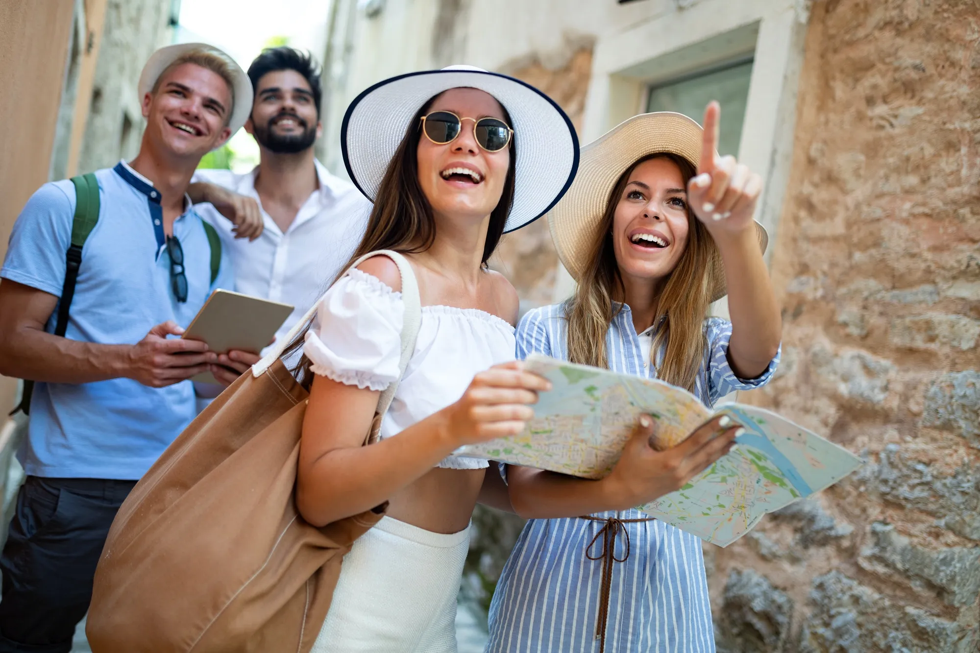 Group of friends tourists with map in old city on vacation