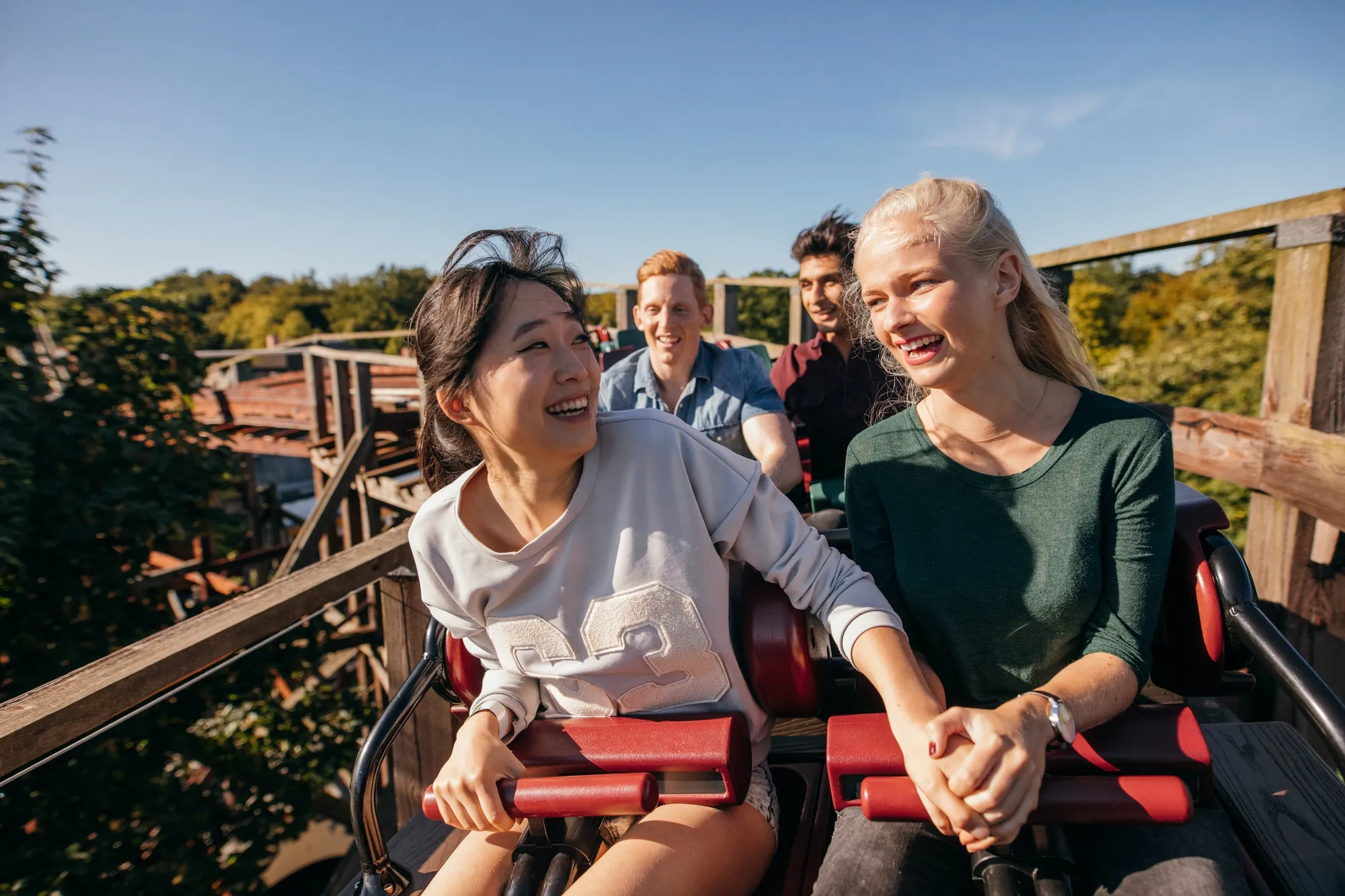 Young friends riding roller coaster